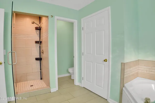 a bathroom with a shower and toilet