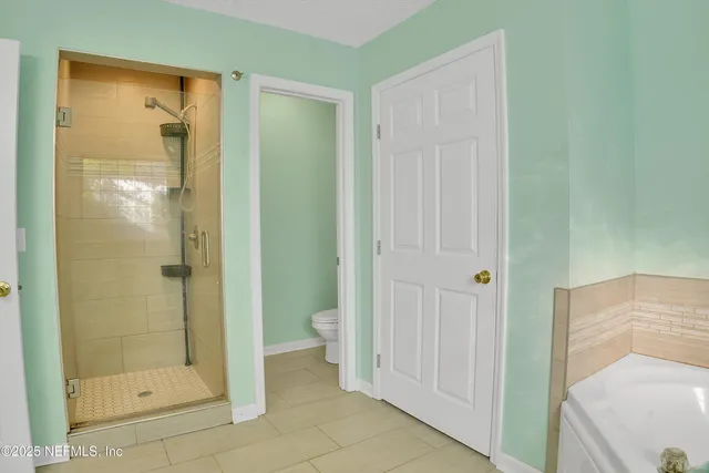 a bathroom with a shower and a toilet