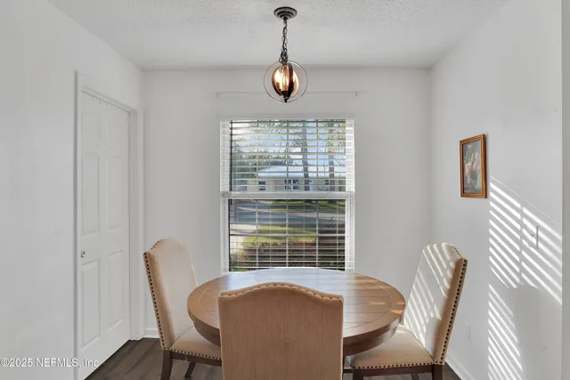 a view of a dining room with furniture window and outside view