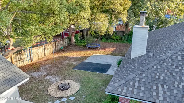 a view of a backyard with a tree