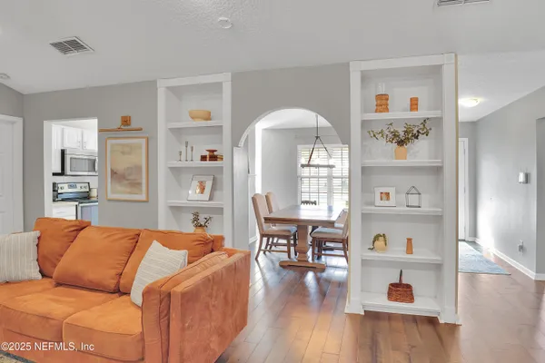 a living room with furniture and wooden floor
