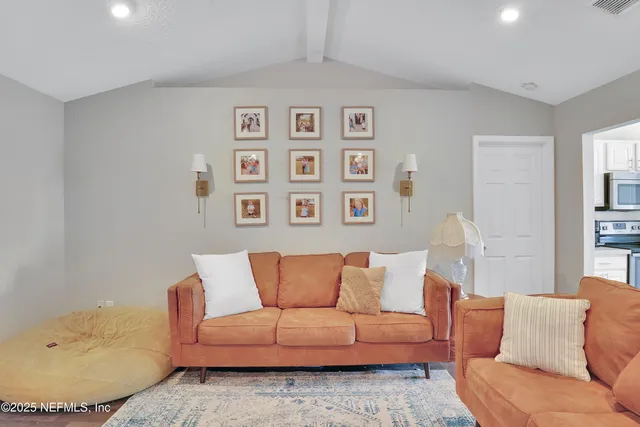 a living room with furniture and painting on the wall