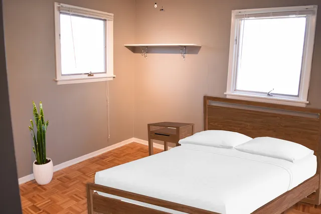 a bedroom with a bed and window