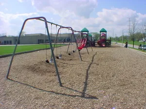 a view of a park with swings and slides