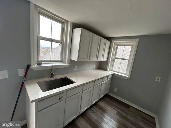 a kitchen with a sink and cabinets