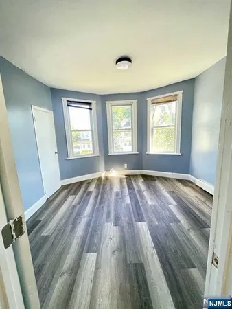 a view of wooden floor and windows in a room
