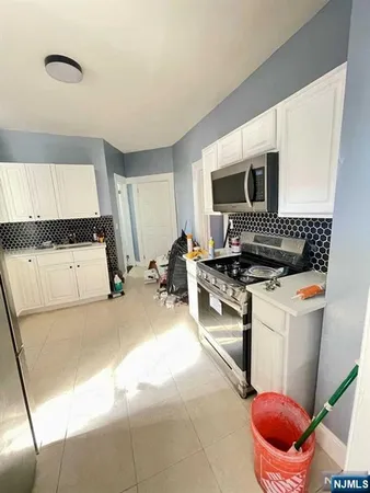 a kitchen with a stove and a refrigerator