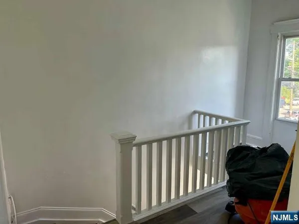 a view of a bedroom with furniture and a window