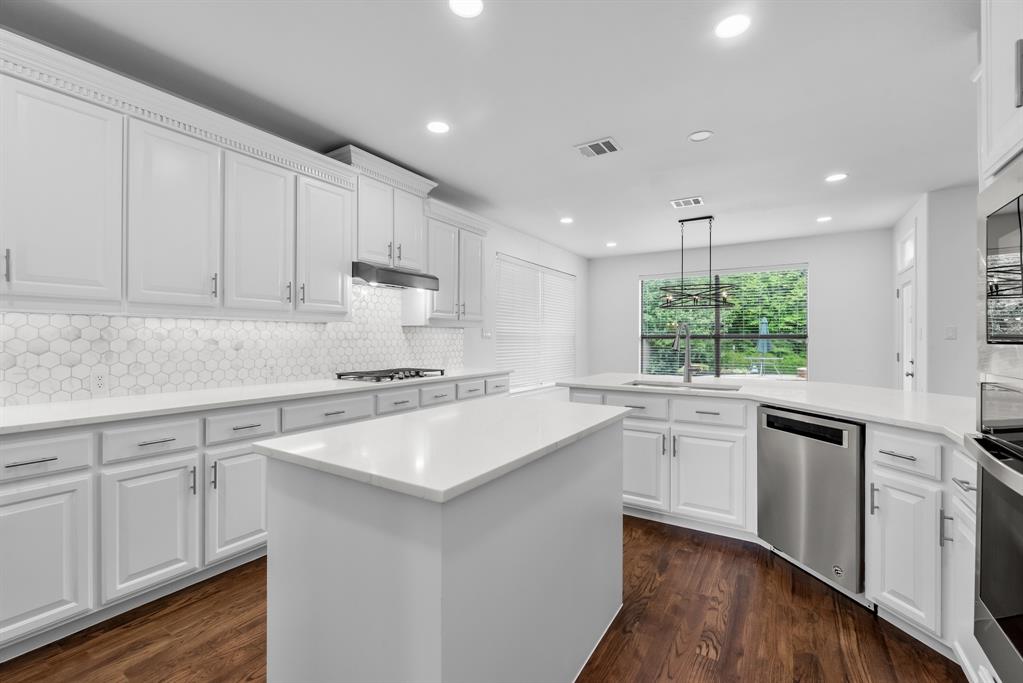 1013 Siena Drive Southlake, TX 76092 - Photo 12 of 31 a kitchen with kitchen island white cabinets and white appliances