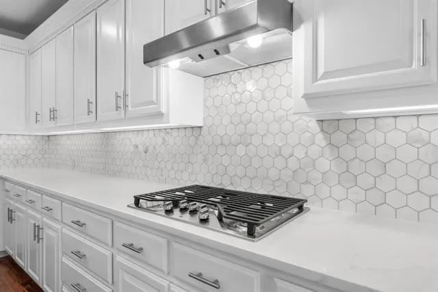 a stove top oven sitting inside of a kitchen