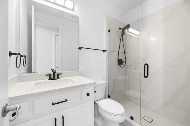 a bathroom with a sink toilet and shower