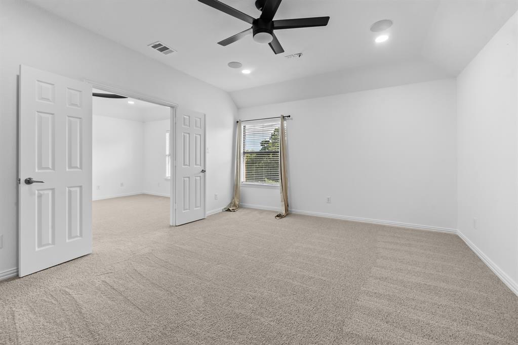 1013 Siena Drive Southlake, TX 76092 - Photo 24 of 31 an empty room with chandelier fan
