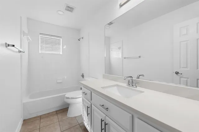 a bathroom with a double vanity sink toilet and shower