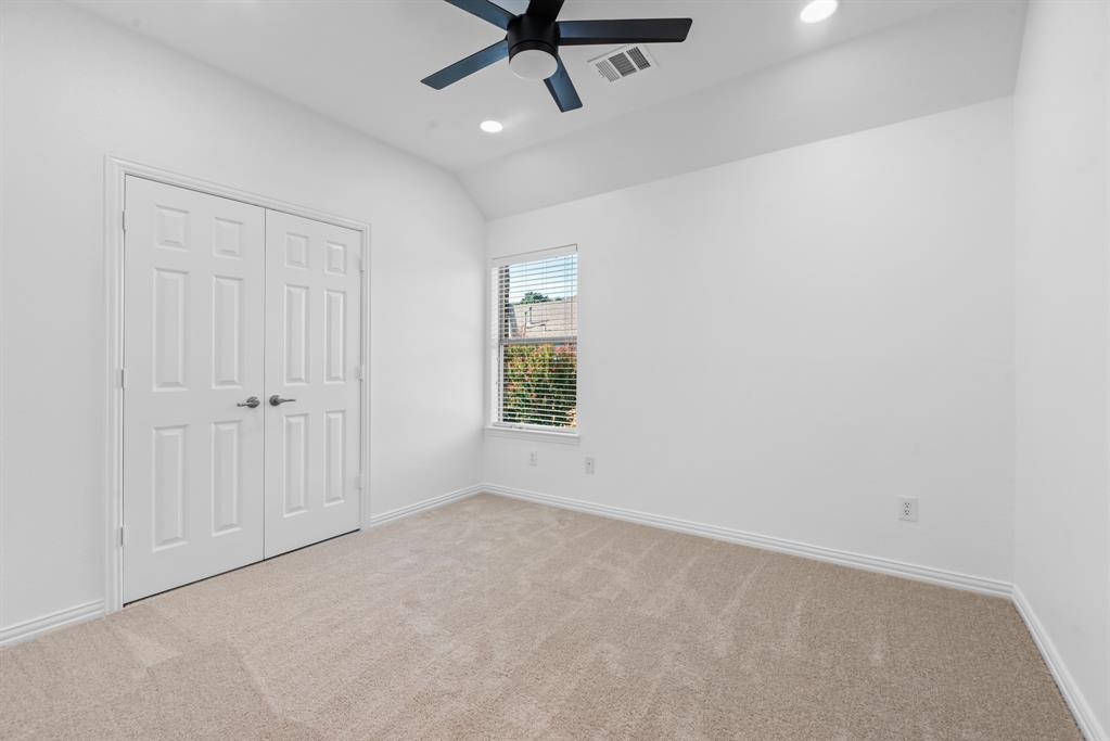 1013 Siena Drive Southlake, TX 76092 - Photo 27 of 31 an empty room with a window and a ceiling fan