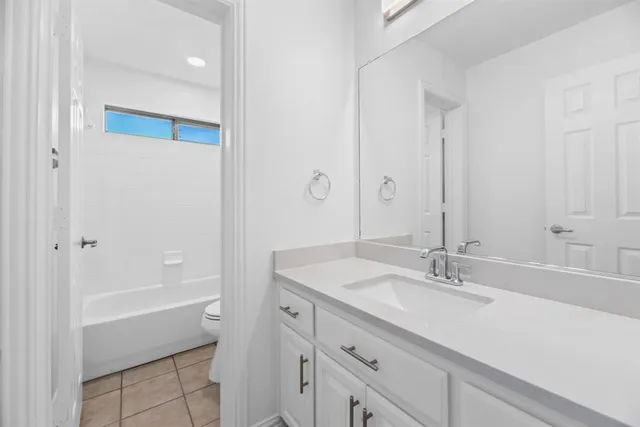 a bathroom with a sink double vanity and a bathtub