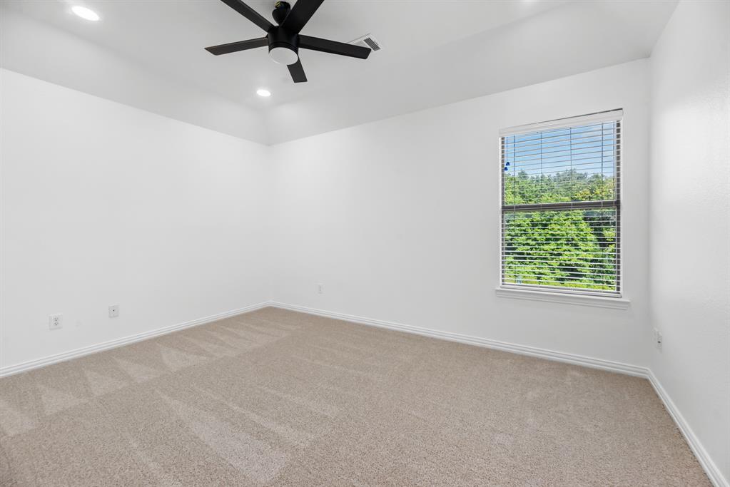 1013 Siena Drive Southlake, TX 76092 - Photo 29 of 31 an empty room with a window and a fan