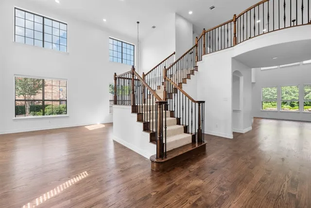 a view of entryway with wooden floor and front door