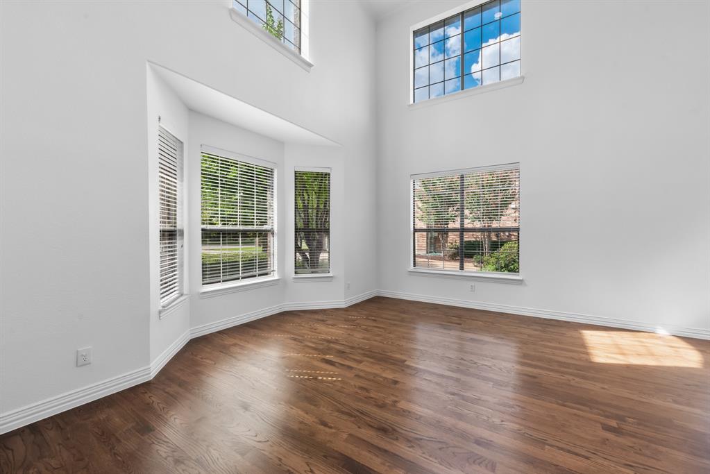 1013 Siena Drive Southlake, TX 76092 - Photo 4 of 31 an empty room with wooden floor and windows