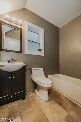 a bathroom with a sink toilet and mirror