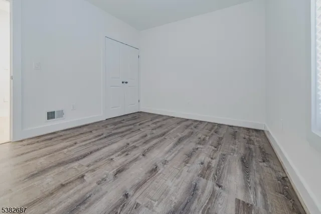 a view of room with wooden floor