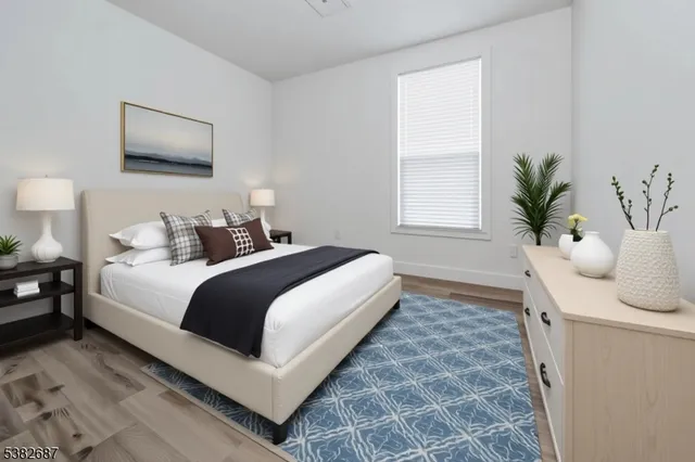 a bedroom with bed and a potted plant