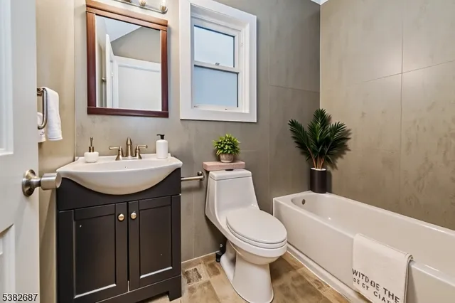 a bathroom with a toilet a sink and mirror