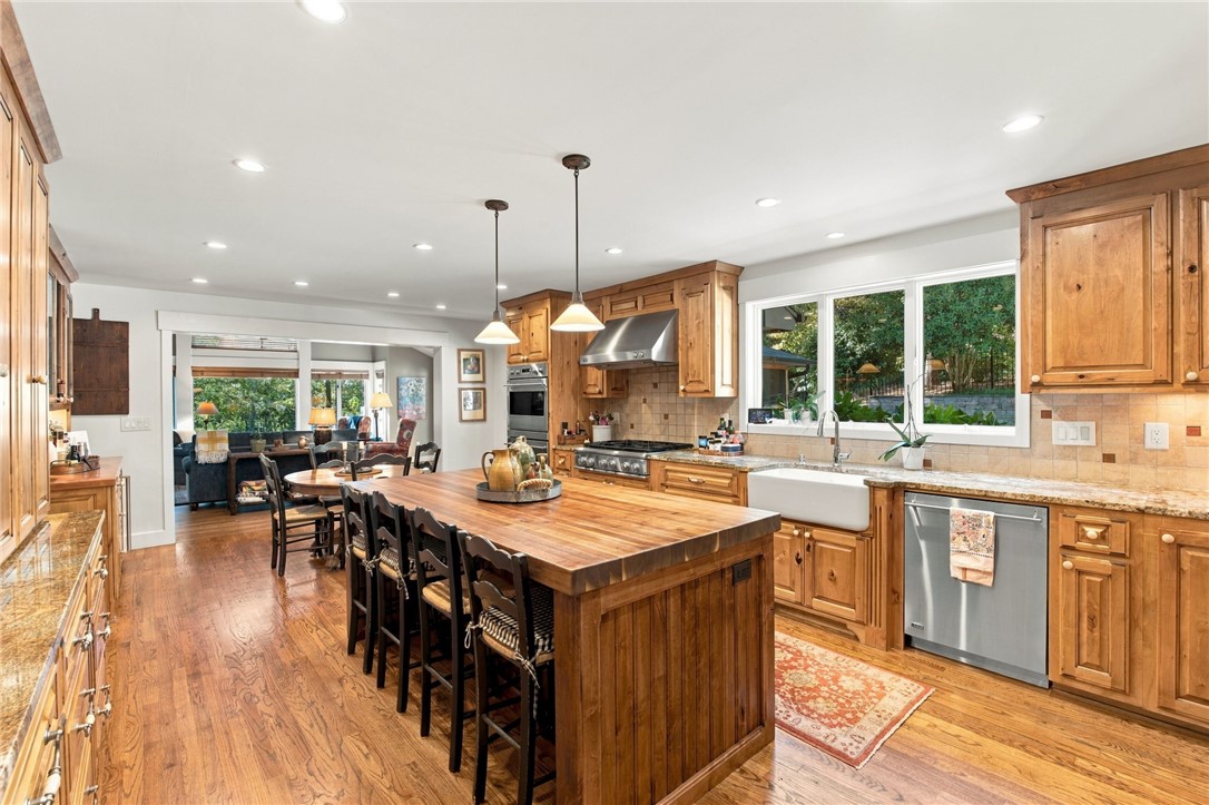 604 Ridgecrest Drive Clemson, SC 29631 - Photo 18 of 50 Rich wood cabinetry and a generous central island anchor this open-concept culinary space.