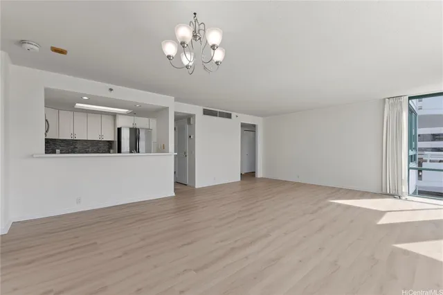 a view of a kitchen with wooden floor and a kitchen