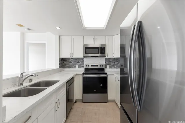 a kitchen with a sink and a refrigerator