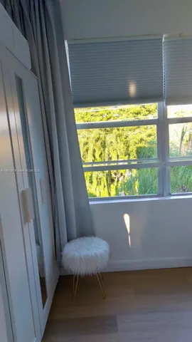 a bedroom with a bed and a large mirror