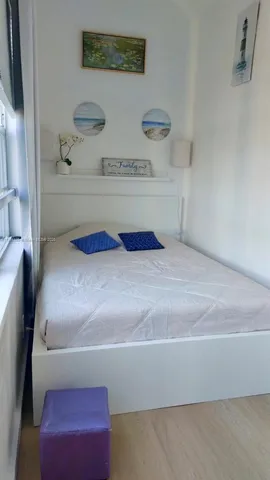 a white toilet sitting next to a shower curtain