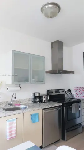 a kitchen with stainless steel appliances granite countertop a sink and a stove