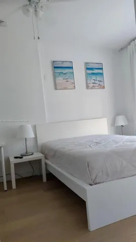 a bedroom with a bed and lamp