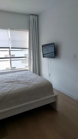 a bedroom with a bed a dresser and a window