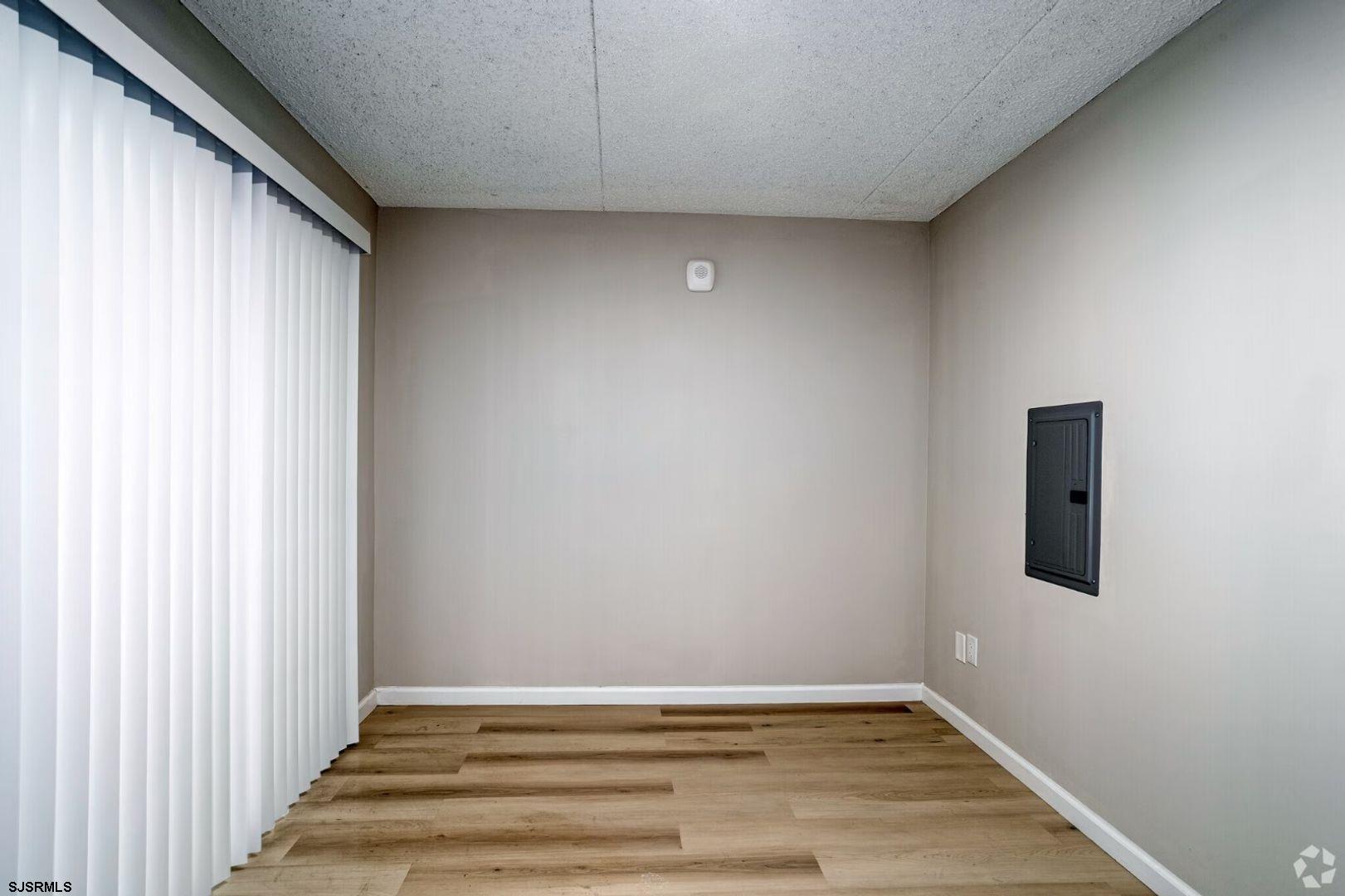 2580 Tilton Road, Unit 34 Egg Harbor Township, NJ 08234 - Photo 11 of 12 a view of an empty room with wooden floor and a window