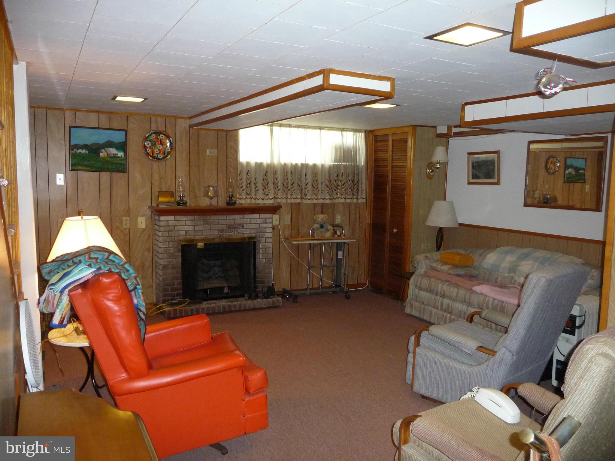 1751 Amuskai Road Baltimore, MD 21234 - Photo 22 of 27 a living room with furniture and a fireplace