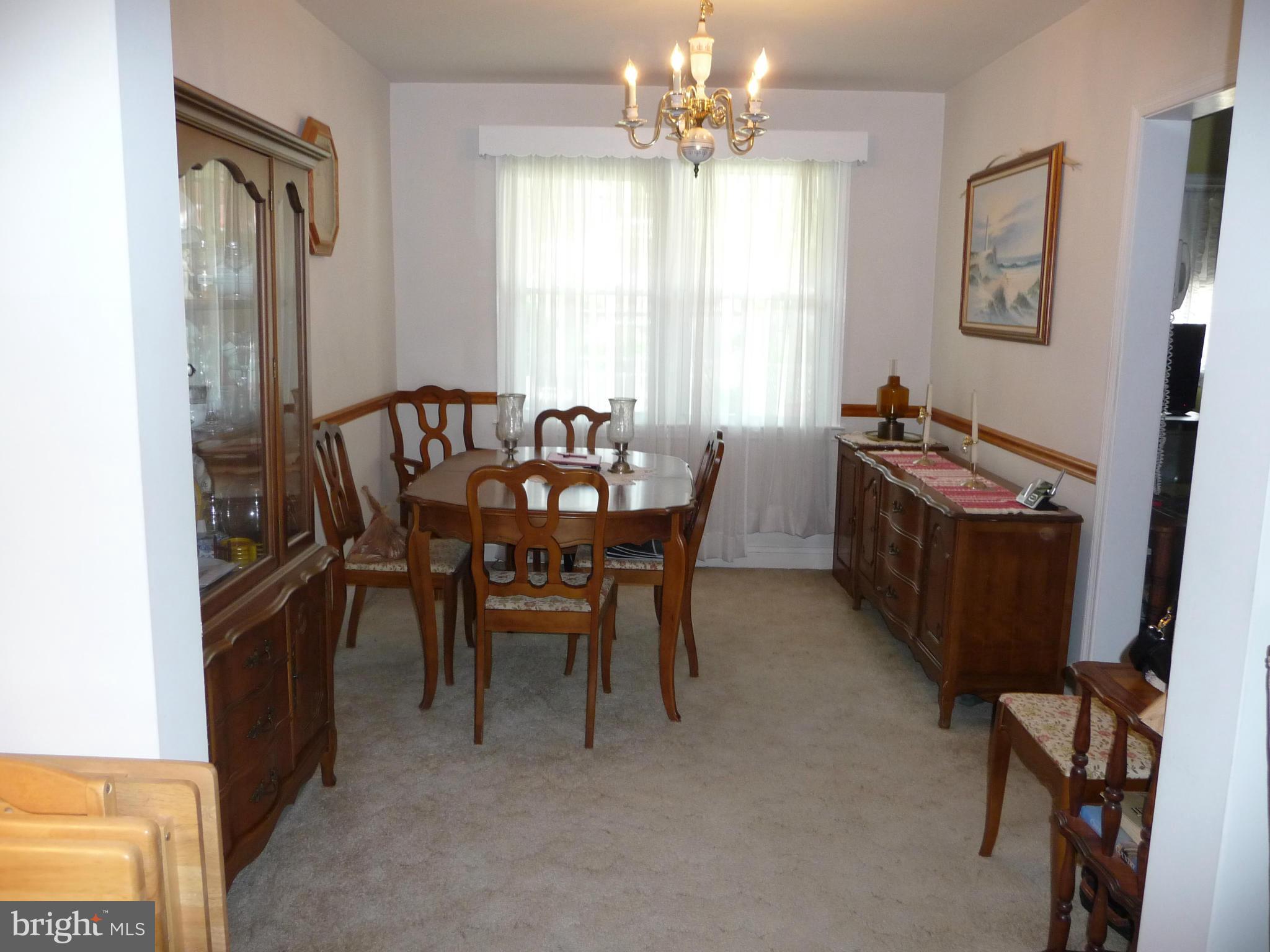 1751 Amuskai Road Baltimore, MD 21234 - Photo 5 of 27 a view of a dining room with furniture and a chandelier