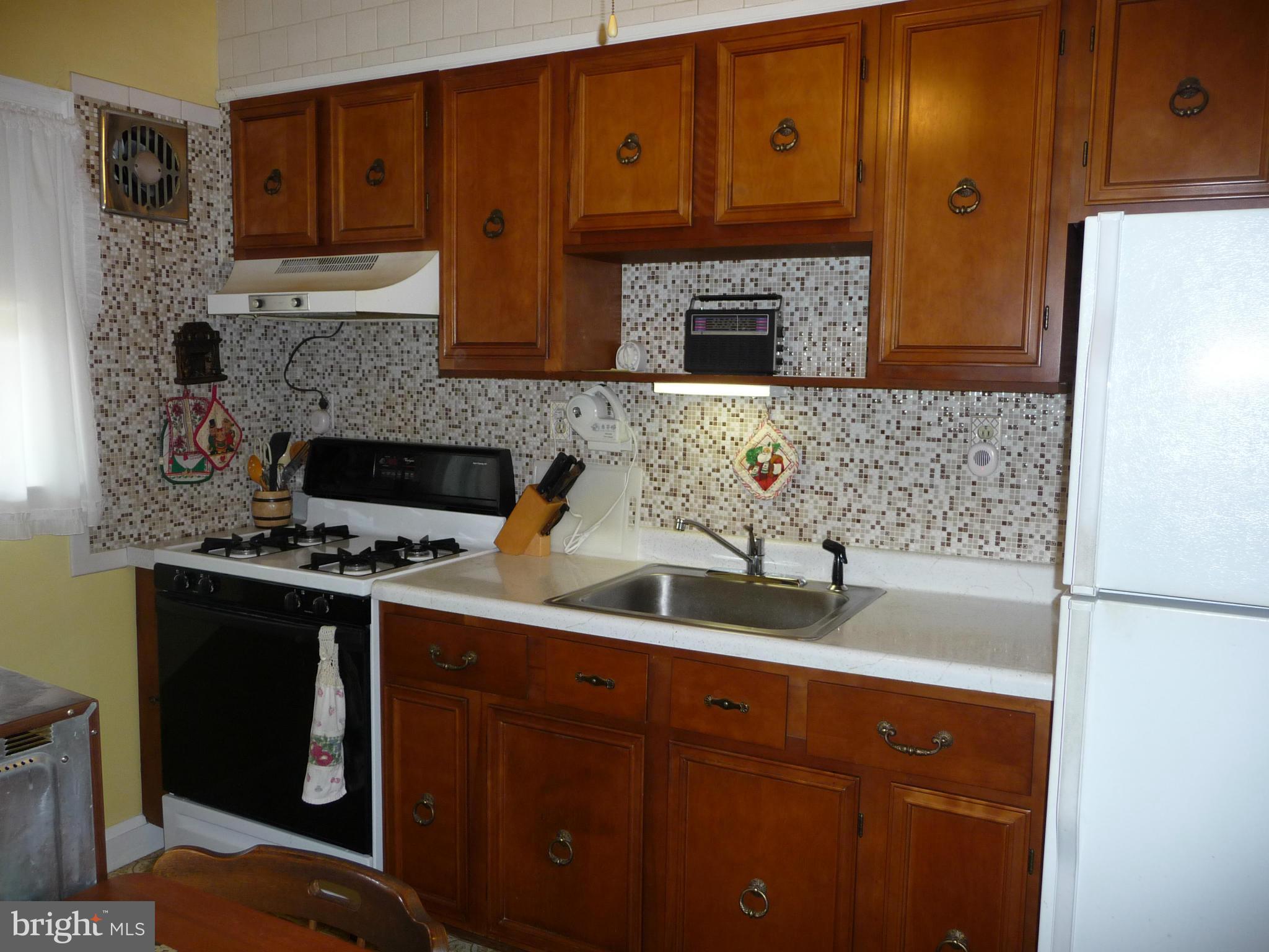 1751 Amuskai Road Baltimore, MD 21234 - Photo 6 of 27 a kitchen with stainless steel appliances granite countertop a sink stove and refrigerator