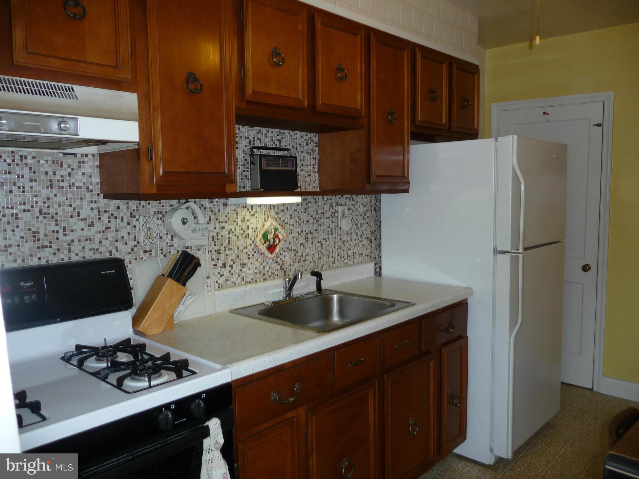 1751 Amuskai Road Baltimore, MD 21234 - Photo 7 of 27 a kitchen with stainless steel appliances granite countertop a sink stove and refrigerator