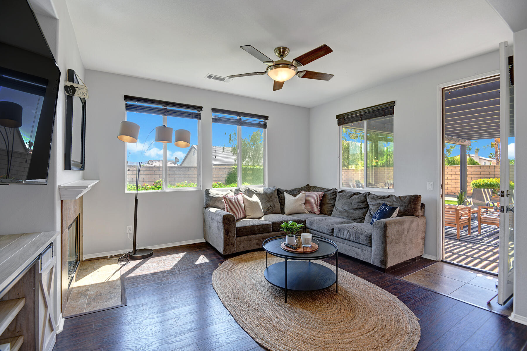 37232 Melbourne Street Indio, CA 92203 - Photo 11 of 30 a living room with furniture a chandelier and a window