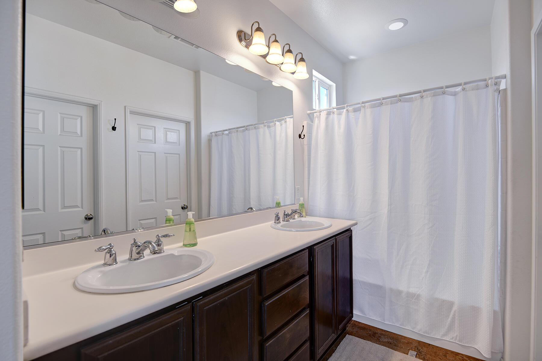 37232 Melbourne Street Indio, CA 92203 - Photo 17 of 30 a bathroom with a double vanity sink and a mirror
