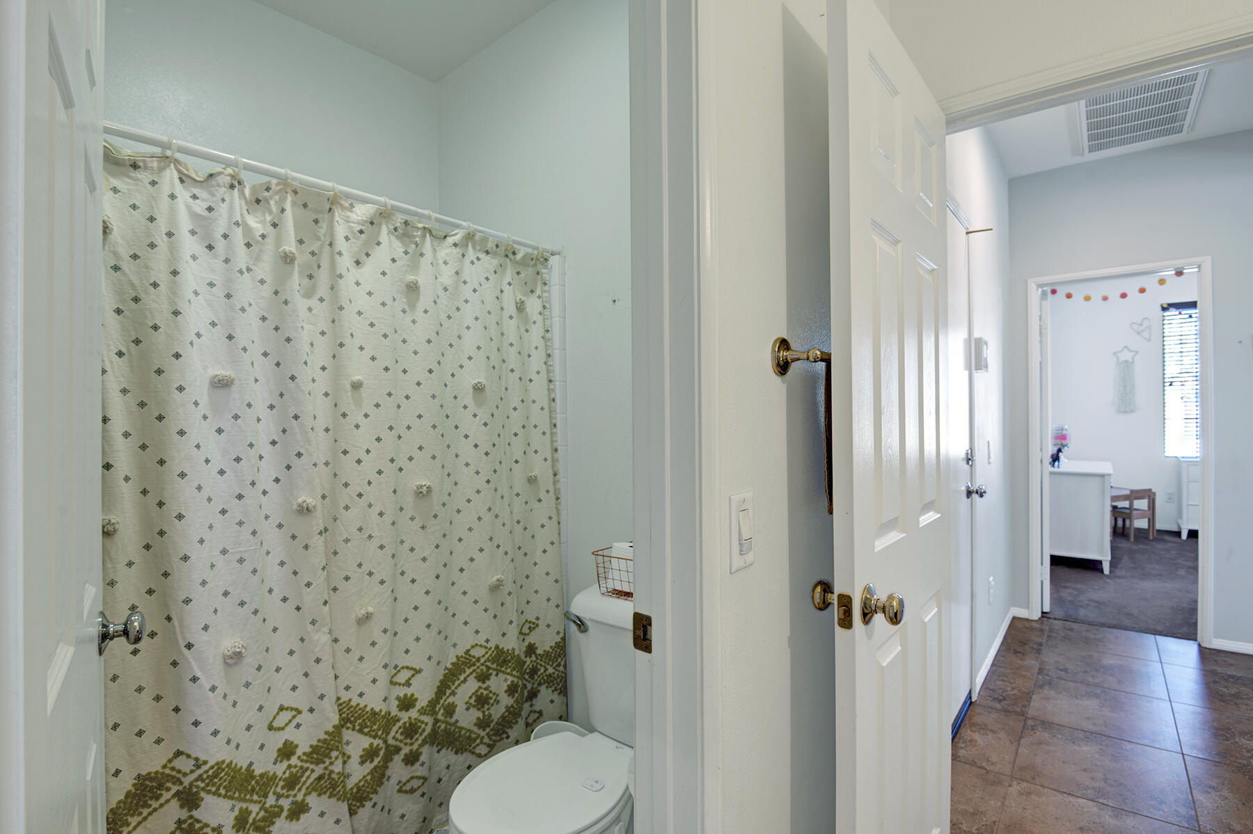 37232 Melbourne Street Indio, CA 92203 - Photo 21 of 30 a bathroom with a shower curtain