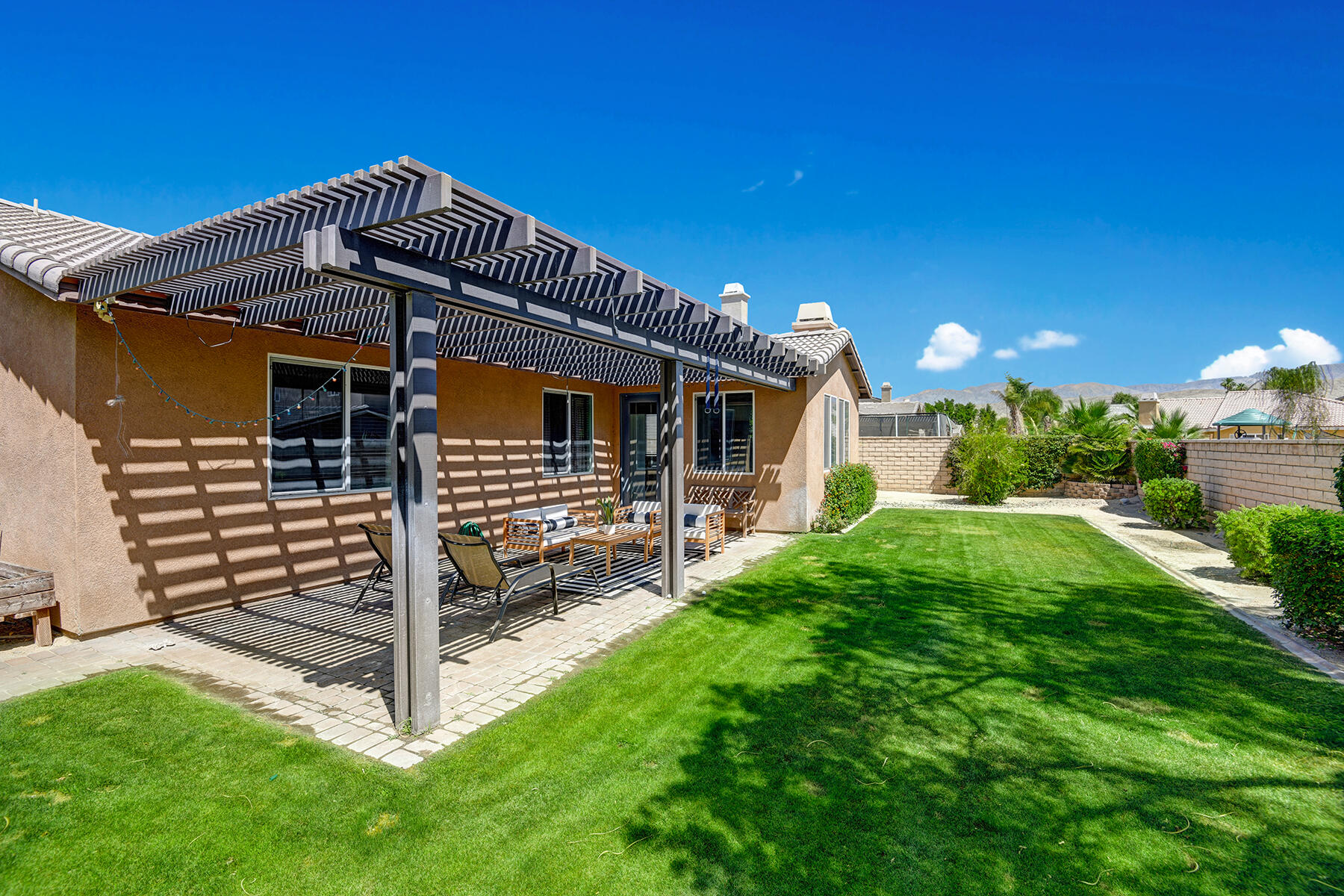 37232 Melbourne Street Indio, CA 92203 - Photo 27 of 30 a front view of a house with a yard