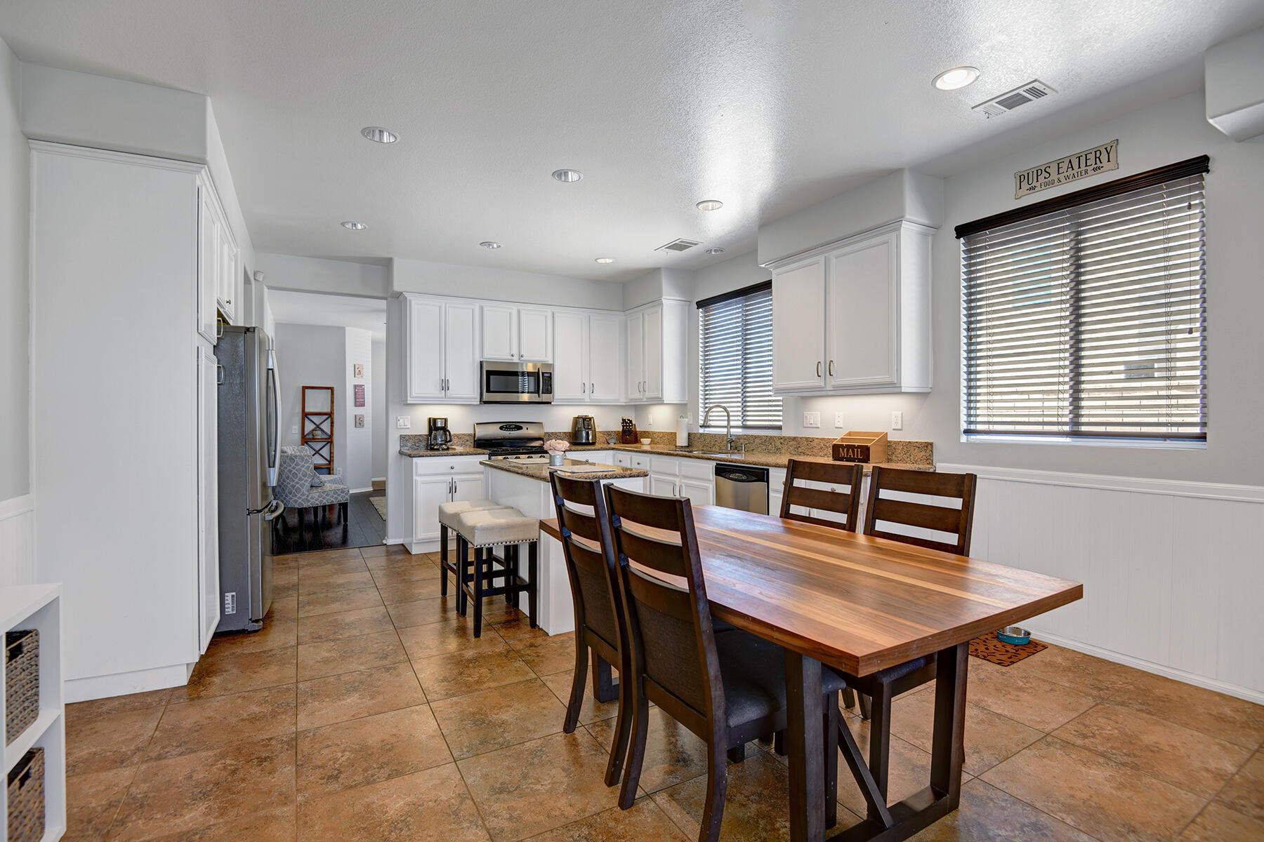 37232 Melbourne Street Indio, CA 92203 - Photo 6 of 30 a kitchen with a dining table chairs and refrigerator