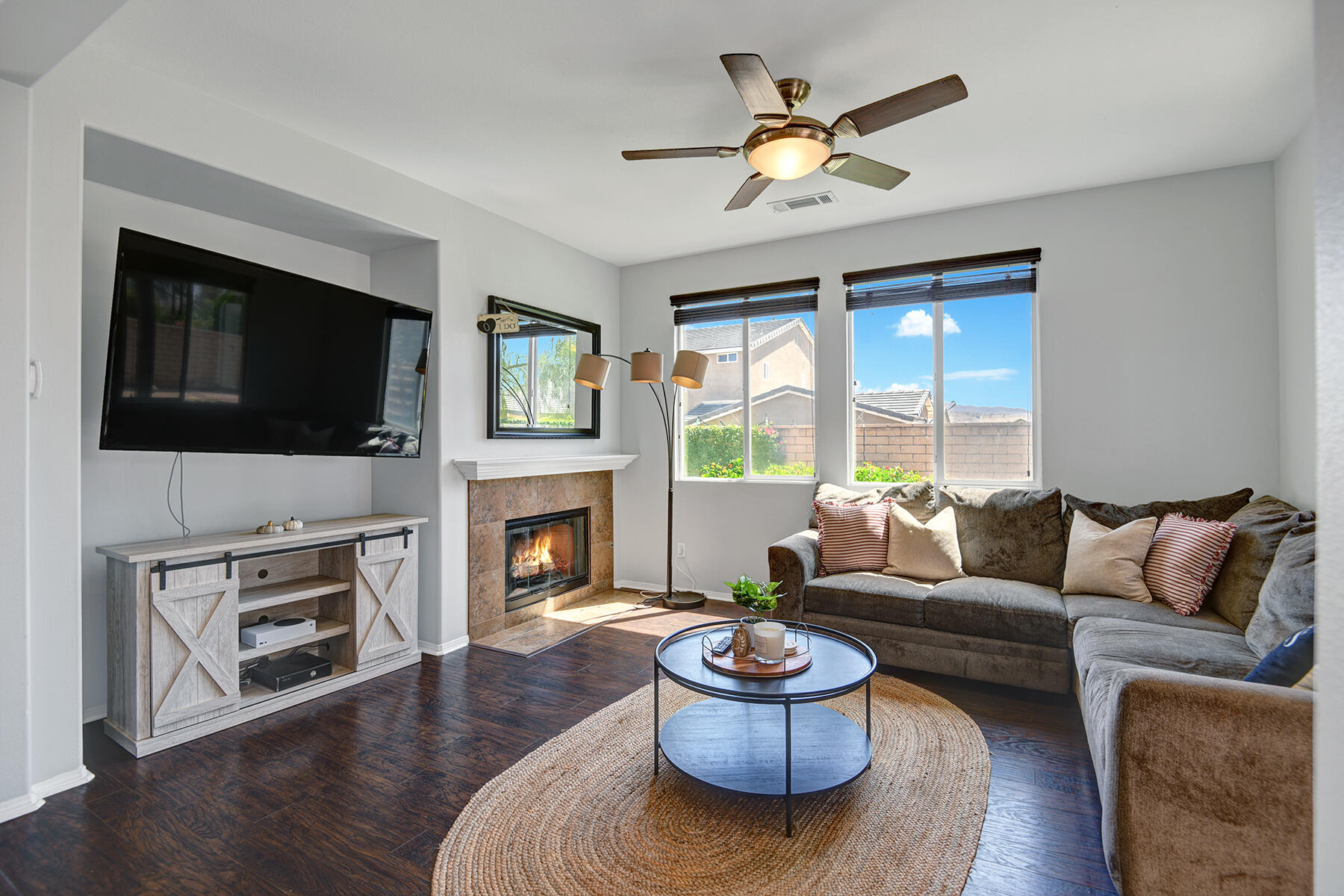 37232 Melbourne Street Indio, CA 92203 - Photo 10 of 30 a living room with furniture a fireplace and a flat screen tv