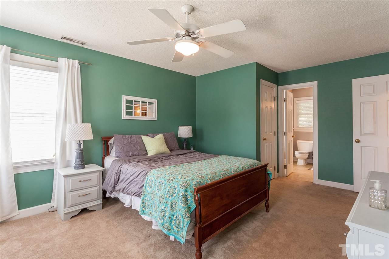 4301 Emmit Drive Raleigh, NC 27604 - Photo 22 of 30 a bedroom with a bed and a chandelier