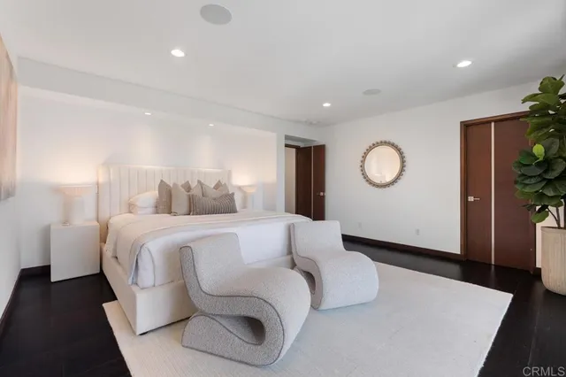 a spacious bedroom with a large bed and a large window