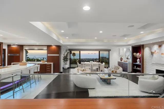 a living room with furniture large window and a table
