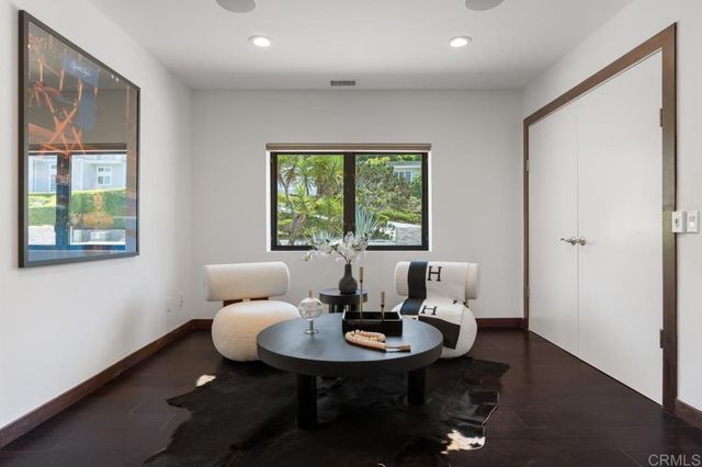 a bathroom with a toilet a sink a mirror a vanity and window