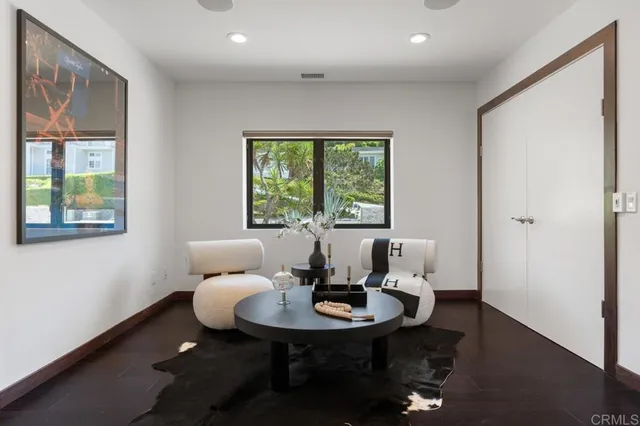 a bathroom with a toilet a sink a mirror a vanity and window